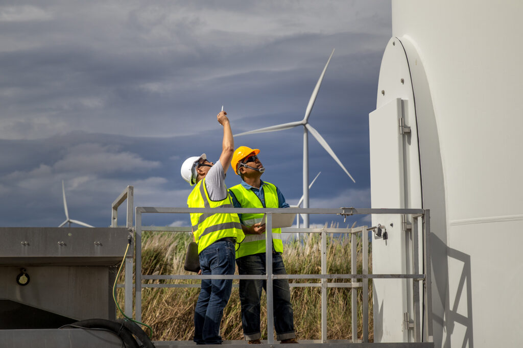 Engineers and staff are inspecting and checking the wind turbine's power generation system.