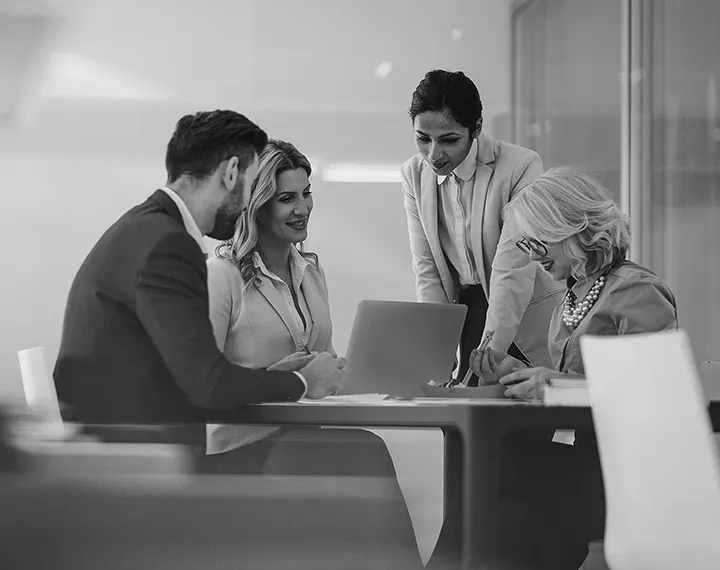 A diverse group of business professionals collaborating in a modern office setting.